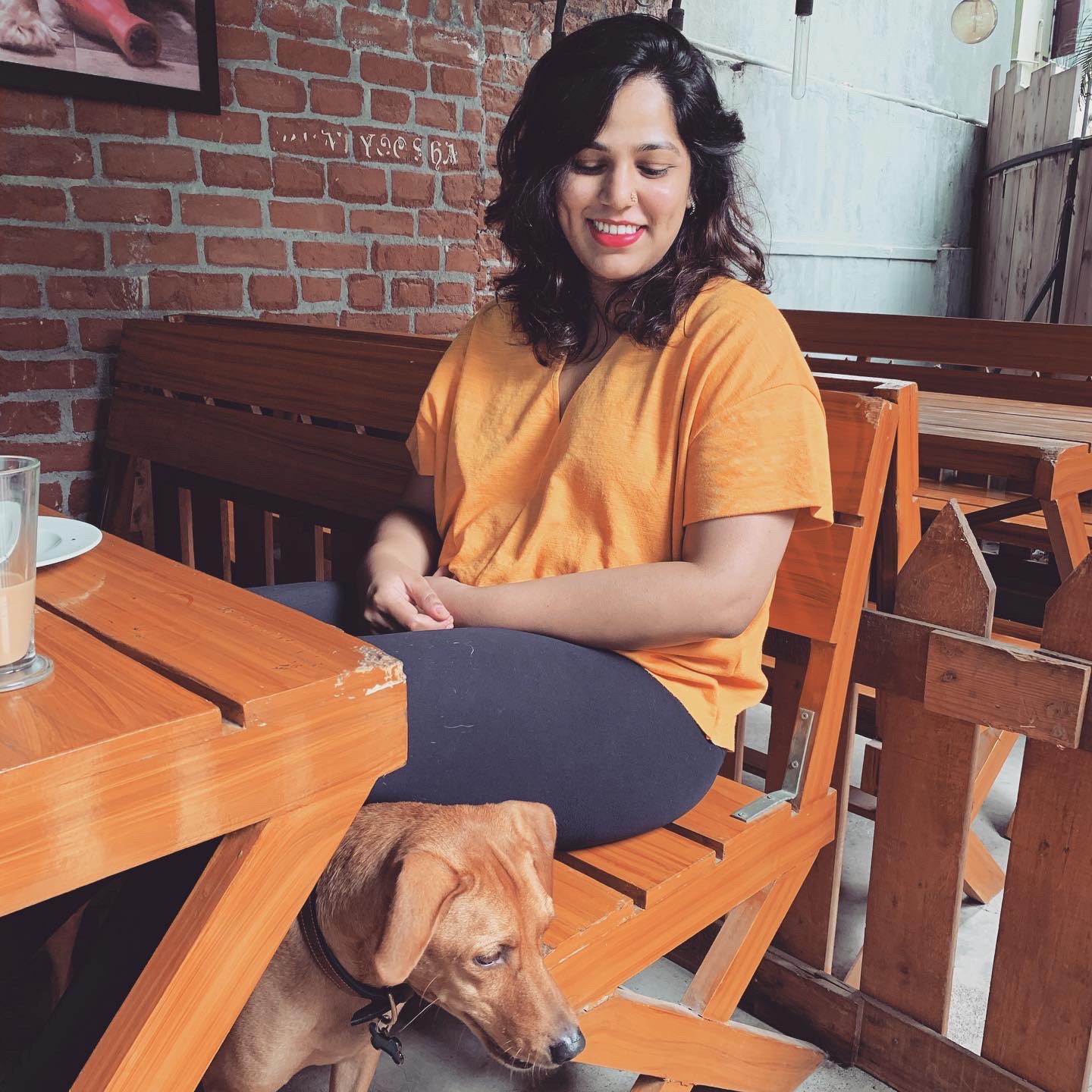 Sanjana at a cafe with a dog