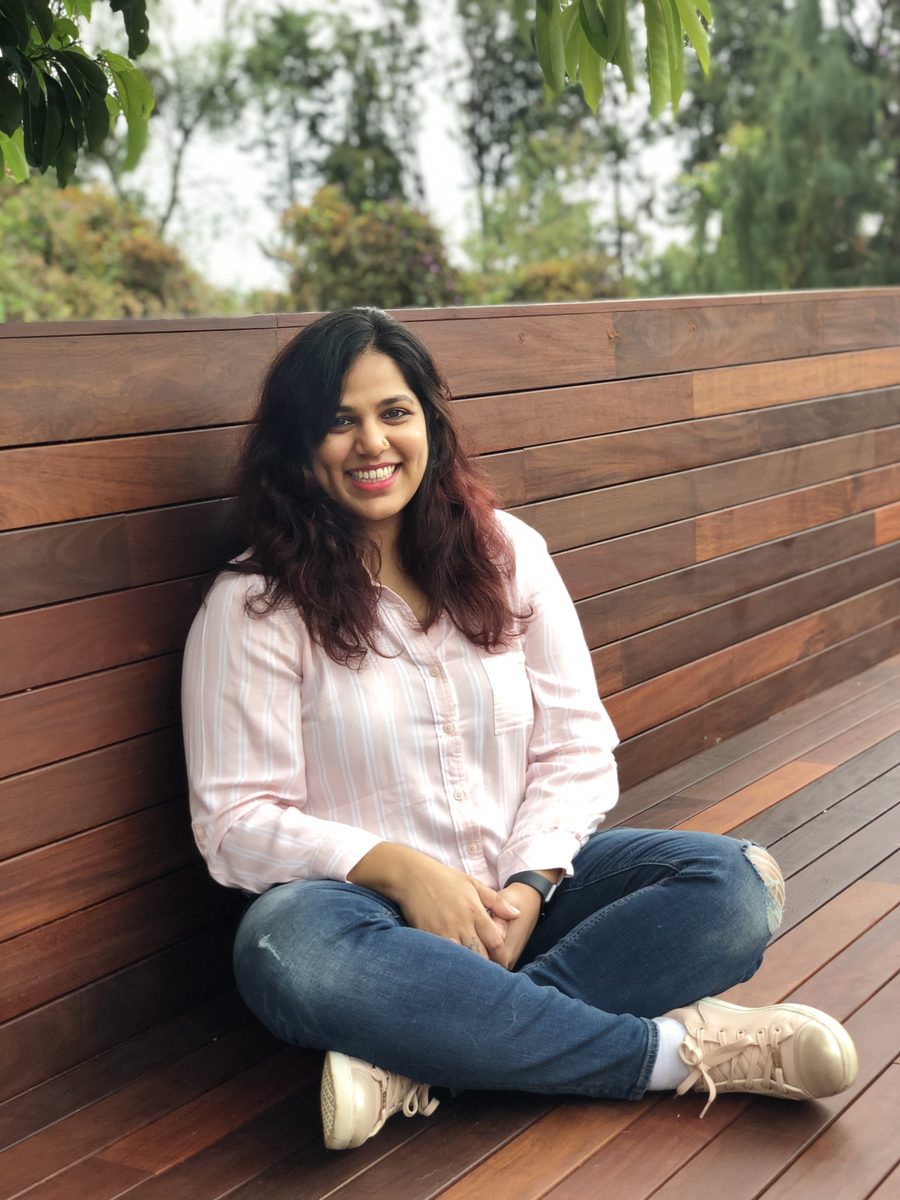 Sanjana, founder of ChapterOne Creative, smiling outdoors